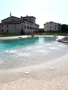 a pool of water with two frisbees on the beach at Agriturismo Casalbergo in Isola della Scala