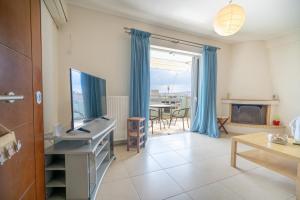 a living room with a flat screen tv and a table at Sygrou - fix 2 bedrooms 5 persons apartment by MPS in Athens
