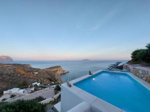 a swimming pool with a view of the ocean at Apollon Village Hotel in Anafi