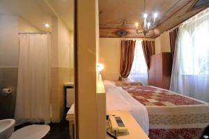 Postel nebo postele na pokoji v ubytování Hotel Iris