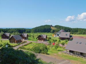 an aerial view of a village with houses and trees at Awone Shirakami Juniko in Fukaura