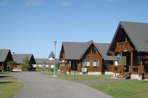 a log cabin building with a road in front of it at Awone Shirakami Juniko in Fukaura