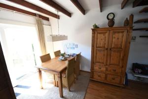 a dining room with a wooden table and a large window at Vrijvakantiehuis Blumstraat 1 in Aagtekerke