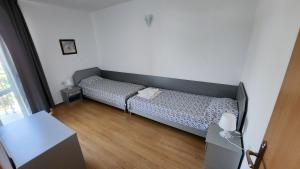 Dormitorio pequeño con cama y mesa en Nushev Hotel, en Sveti Vlas