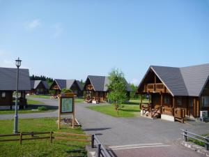 a group of wooden cottages in a park at Awone Shirakami Juniko in Fukaura