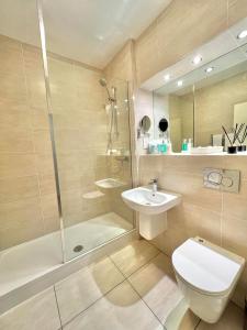 a bathroom with a toilet and a shower and a sink at Garvock House Hotel in Dunfermline