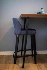 a blue chair sitting at a wooden desk at Hôtel de la Baie in Crozon