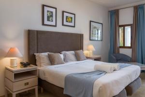 a hotel room with two beds and two lamps at Hotel Ta' Cenc & Spa in Sannat