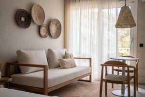 a living room with a couch and a window at Apartamentos Top Secret Es Pujols - Formentera Vacaciones in Es Pujols