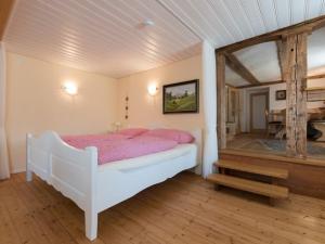 a bedroom with a white bed and a mirror at Haus Belchenwind in Münstertal