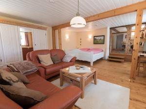 a living room with a couch and a bed at Haus Belchenwind in Münstertal