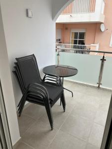 dwa krzesła i stół na balkonie w obiekcie Hostal - Restaurante Playa Azul w mieście Villaricos