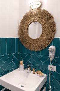 a bathroom with a sink and a mirror on the wall at Relais del Mare in Sorrento