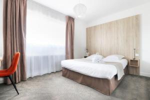 a bedroom with a bed and a large window at Hôtel La Petite Sirène Quiberon in Quiberon