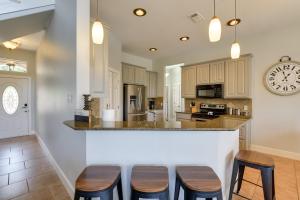 a kitchen with wooden stools and a counter top at Spacious Lake Granbury Vacation Rental with Dock! in Granbury