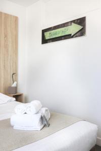 a hotel room with a bed with towels on it at Hôtel La Petite Sirène Quiberon in Quiberon