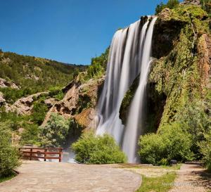 a waterfall on the side of a mountain at Apartman Stela in Knin