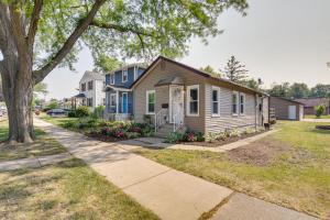 a house on a street with a tree at Des Plaines Vacation Rental with Spacious Backyard! in Des Plaines