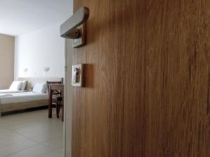 a door to a room with a bed and a bedroom at Papadatos Studios in Argostoli