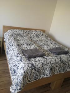 a bed with two pillows on it in a room at Apartamenty Elbląska 20A in Braniewo