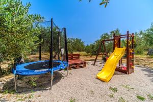 a playground with a slide and a slideintend at Island Getaway - Heritage House with heated pool in Mirce