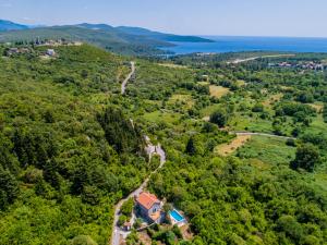 an aerial view of a house in the middle of a forest at Villa Toscana in Tivat