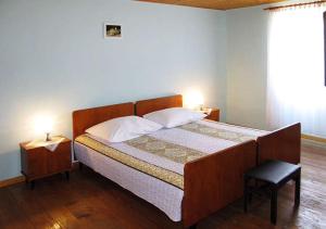 a bedroom with a large bed with a wooden headboard at Country house Viskic in Supetarska Draga