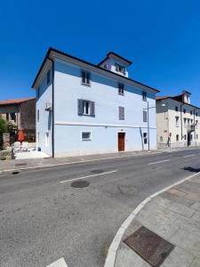 a white building on the side of a street at Silvo Apartments in Koper