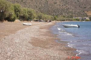 a beach with two boats sitting on the shore at Demos Studios in Kandia