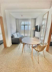 a living room with a table and chairs and a couch at Hotel Zhong Hua in Sopot