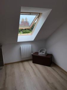 a room with a skylight and a table and a window at Au p’tit nid douillet de Léa in Muhlbach-sur-Munster