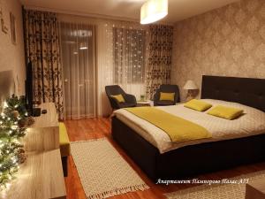 a bedroom with a bed and a christmas tree at Apartment Pamporovo Palaсe A75 in Pamporovo