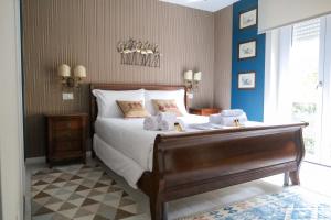 a bedroom with a large bed with towels on it at Hermitage Suites in Sassari