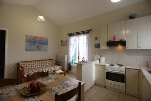 a kitchen and dining room with a table and a dining room at SummerAndros Meliti in Andros