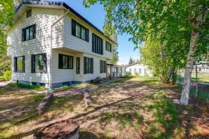 an empty yard in front of a white house at Fairbanks Vacation Rental with Aurora Views! in Fairbanks