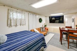 a bedroom with a bed and a desk and a tv at Pet-Friendly Fairbanks Studio with Fenced-In Yard! in Fairbanks