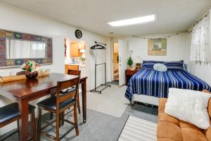 a bedroom with a bed and a table and a kitchen at Pet-Friendly Fairbanks Studio with Fenced-In Yard! in Fairbanks