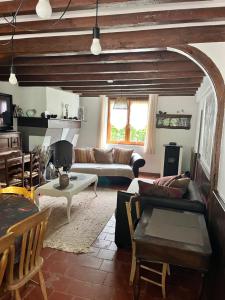 a living room with a couch and a table at Les gîtes du petit mila in Labrit