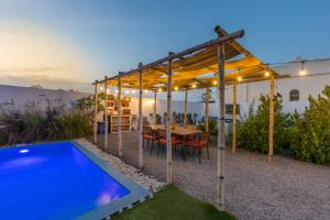 a patio with a table and a swimming pool at My Way in Ras al Khaimah