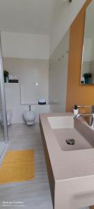 a white bathroom with a sink and a toilet at Sienda Cesira in Muravera