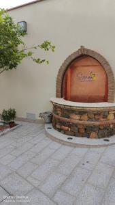 a brick fire pit in the side of a building at Sienda Cesira in Muravera