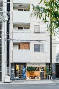 a white building with a store in front of it at SuiteRoom Hana in Osaka