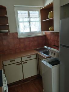 a small kitchen with a stove and a window at Haus Maria in Neubach