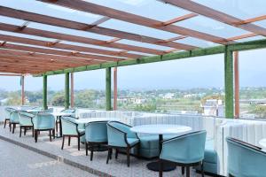 a row of tables and chairs on a roof at Hotel 7 Heaven in Dehradun