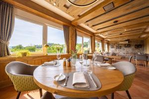 a dining room with a large wooden table and chairs at Weinhotel Pfeffer & Salz in Gengenbach