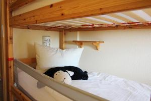 a stuffed animal sitting on top of a bunk bed at Muschel in Bliesdorf