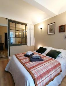 1 dormitorio con 1 cama grande y toallas. en Charmante suite indépendante en maison de village, en Loriol-sur-Drôme