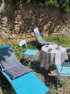a table and two chairs and a table and chairs at Studio jardin in Aubenas