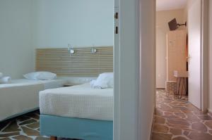a bedroom with two beds and a room with a window at Remvi in Galissas