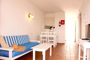 a living room with a couch and a table at Apartamentos Las Pérgolas in Son Parc